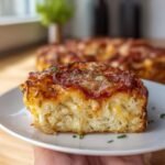 A slice of Pizza Cottage Cheese Bake with a golden crust, pepperoni, and fresh herbs on a white plate.