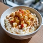 A delicious bowl of Apple Cinnamon Cottage Cheese, topped with diced apples and a sprinkle of cinnamon.