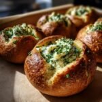 Close-up of Cheesy Thumbprint Appetizers filled with a creamy cheese mixture and garnished with fresh chives.