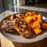Delicious plate of Grilled Chicken & Sweet Potato, perfectly cooked and ready to eat.