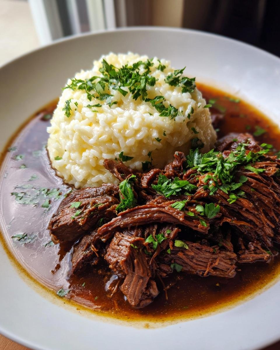 A plate of Italian Pot Roast served with a scoop of Parmesan Risotto, garnished with fresh parsley.