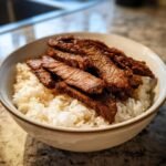 A delicious bowl of Korean BBQ Steak Rice, featuring tender sliced steak over fluffy white rice.