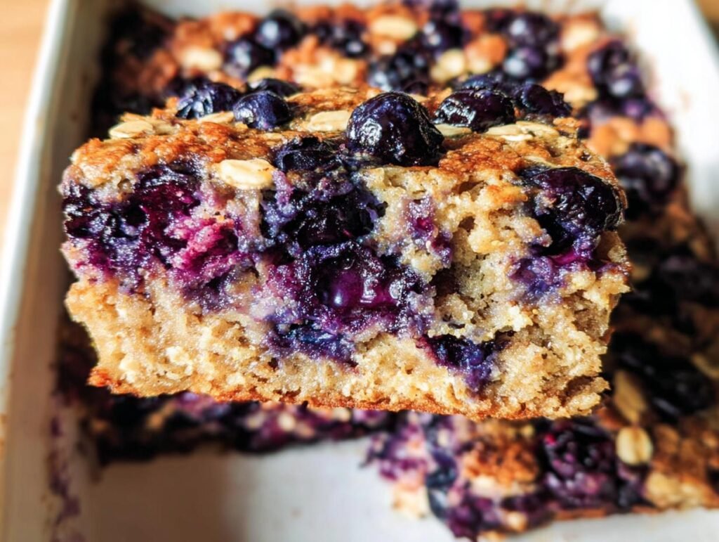 A slice of homemade Blueberry Oatmeal Bake filled with juicy blueberries and hearty oats.