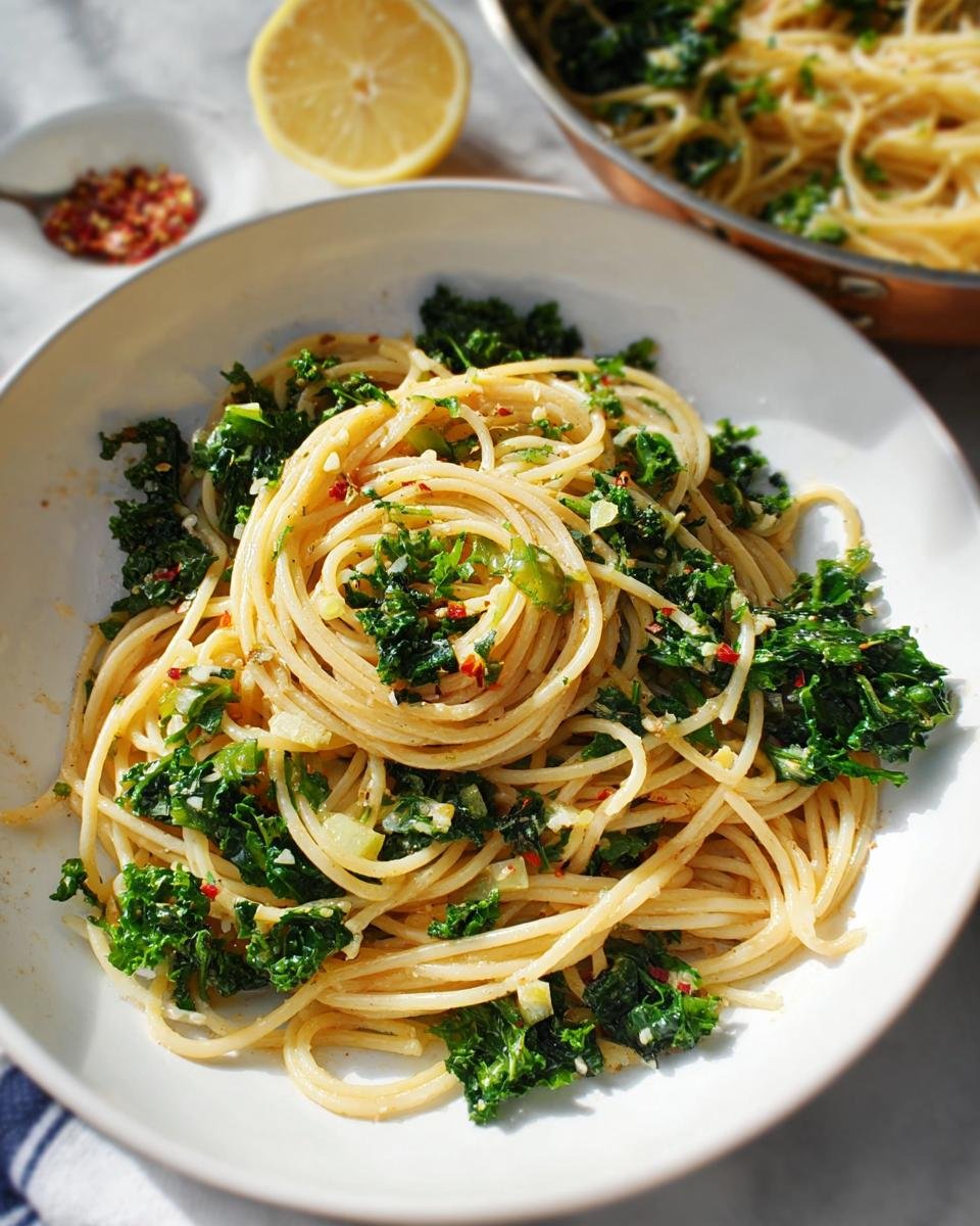 A bowl of spaghetti tossed with sautéed kale, garlic, and red pepper flakes, perfect for easy weeknight dinners.